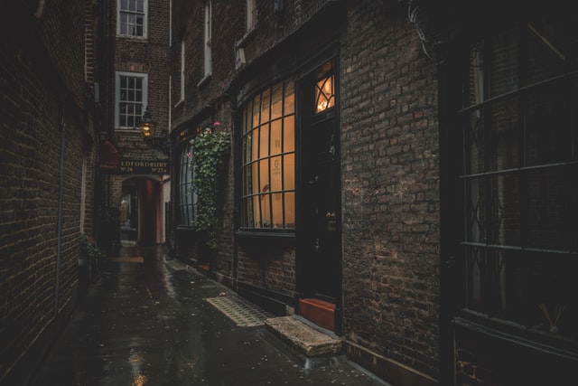 Dimly-lit cobblestone alleyway