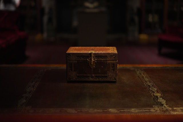 A small gold and red ornate chest