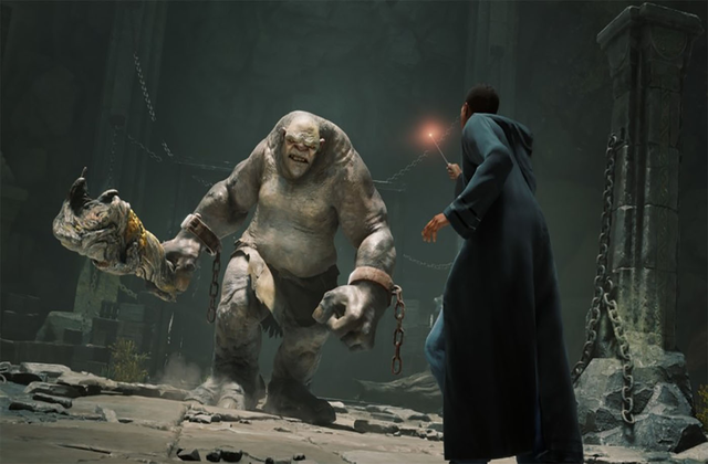 A student holds their wand towards an approaching Mountain Troll